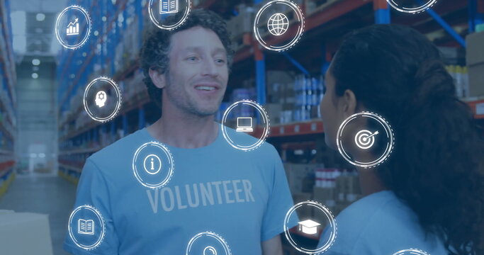 Reviewing male volunteer scanning boxes in warehouse aisle, with digital overlay icons, copy space - Powered by Adobe
