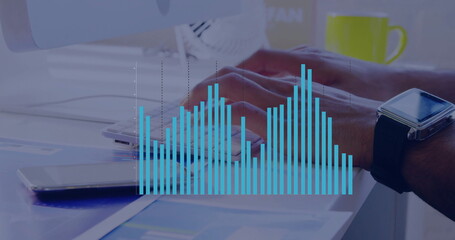 Typing medium-brown forearms pressing keys on office desk, with documents, coffee mug, bar chart