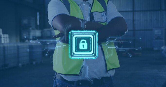 Standing worker wearing safety vest with crossed arms at metal racks, stacked pallets, digital lock - Powered by Adobe