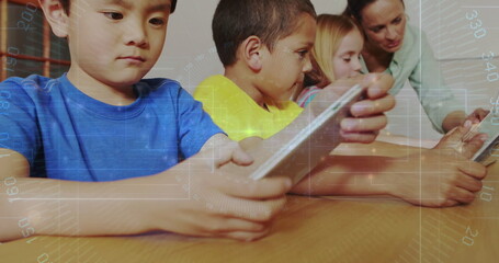 Guiding teacher helping students using tablets on wooden table in classroom, digital learning theme