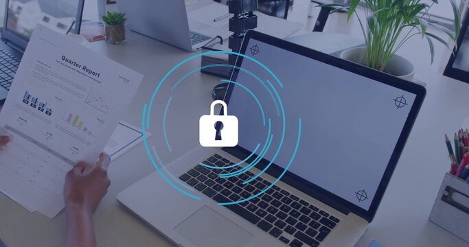 Holding printed Quarter Report sheet on office desk, highlighting laptop padlock and smartphone