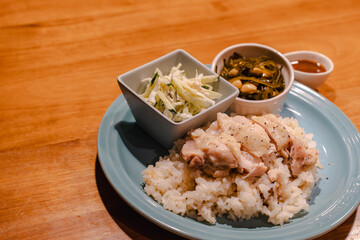 Steamed chicken rice dinner with side dishes
