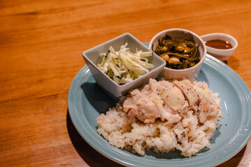 Steamed chicken rice dinner with side dishes
