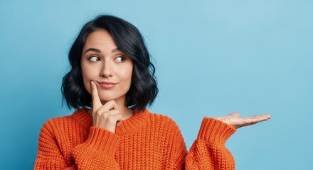 Intrigued Young Woman in Orange Sweater Thoughtfully Presents a Choice on Blue Copy Space.