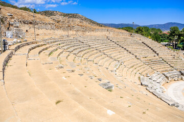 A stone amphitheater with a stage and a few seats, amphitheater. Ruins of the ancient city of Philippi, Greece