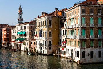 Canal in Venice Italy features colorful buildings and gondolas on a sunny day in the heart of the city