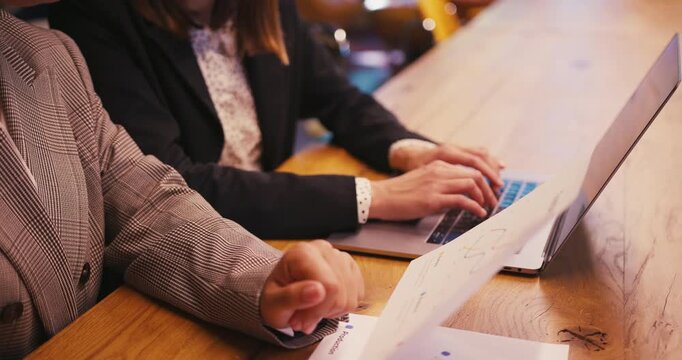 Women compare printed statistics and input into electronic system