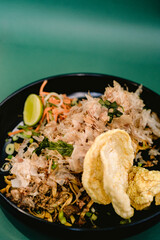 noodle dish topped with dried skipjack tuna shavings, served with sliced carrots, cucumber, spring onions, and lime, and crackers. Japanese food (2)