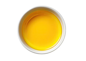 Top-down view of a small, round, white bowl filled with a bright yellow liquid