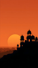 Silhouette of ancient indian temple stands against a vibrant orange sunset sky, creating a serene and mystical atmosphere in the desert landscape.