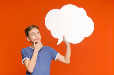 Hm, great idea. Cheerful thoughtful boy looking at speech bubble and contemplating, copy space