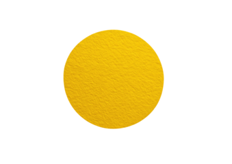 A bright, solid yellow circle on a black background. The circle has a slightly textured, granular surface