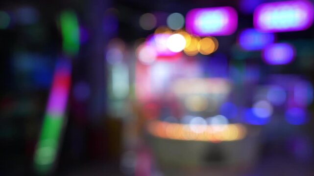 Defocused view of amusement Arcade game center. Toy crane game vending machine