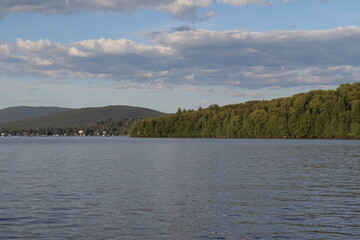 Reflection of the water of a lake with mountains. Summer or autumn calendar. Environment and preservation of lake. Quebec and Canada landscape. Peaceful landscape and zen atmosphere.