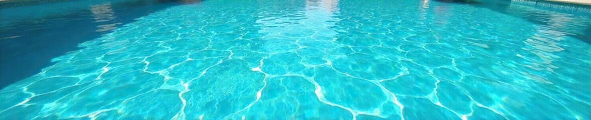 Obraz premium A vibrant turquoise pool shimmers under a bright summer sky, the water crystal clear and inviting Perfect for summer vacation, travel, and relaxation imagery , clear, escape
