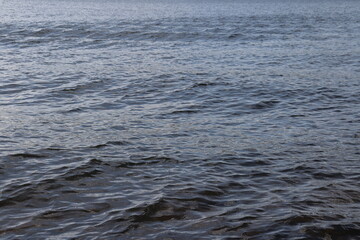 Waves on the lake and water movement. Water background. Blue water in movement. Water preservation and lake activities.