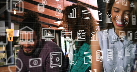 Analyzing three colleagues reviewing data icons overlay at modern office desk with wood beams