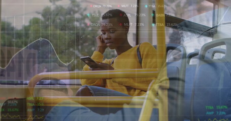 Riding woman in yellow sweater, jeans using smartphone listening on earphones on bus, data overlay