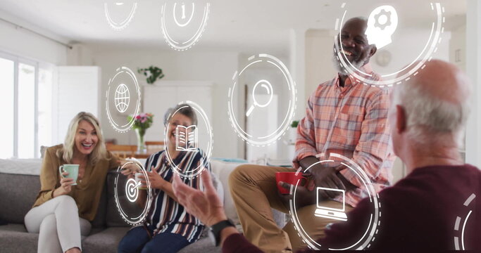 Discussing technology four adults holding mugs and smartphone on couch at home, floating icons