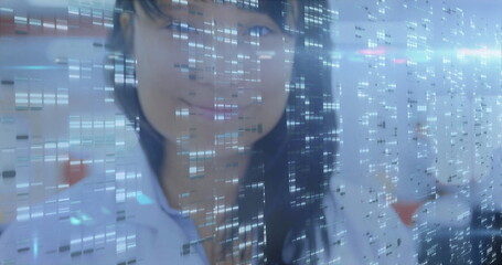 Female scientist studying translucent digital data overlay in research lab, wearing lab coat