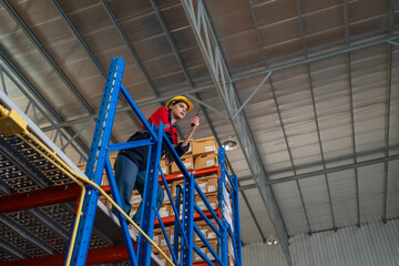 Fototapeta premium Warehouse worker working in warehouse storage. Foreman or worker work at factory site check up products in site. Inventory worker working in factory Storehouse