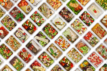 Collection of take away foil boxes with healthy food. Set of containers with everyday meals - meat, vegetables and law fat snacks on white background, top view
