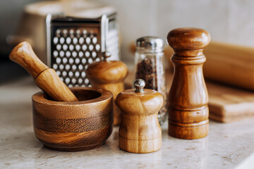 Wooden kitchen utensils and accessories on a marble countertop