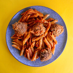 Tasty Italian style meatballs with penne pasta and tomato sauce. 
