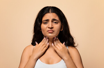 Portrait of unhappy sad sick indian woman suffering from sore throat, ill young eastern lady...