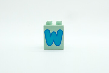 Colorful alphabet W building blocks isolated on a white background. Concept of toy, education, motivation, planning and hope