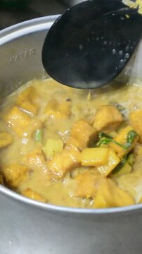 Traditional Indonesian Jenang Gula with Assorted Toppings Being Prepared in Home Kitchen