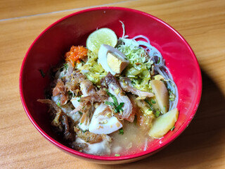 Soto Ayam in Indonesia. Soto ayam is a traditional Indonesian dish that uses ingredients such as shredded chicken, potatoes, eggs, vermicelli, bean sprouts with delicious sauce.