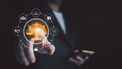 A businessperson in a suit touches a glowing digital interface featuring a central scale of justice icon surrounded by various legal symbols, representing modern legal technology and online services.