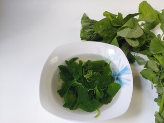 Sayur Bening Bayam or Spinach Clear Soup, isolated on white background 