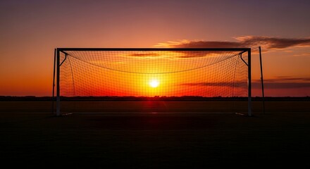Sunset Football Spectacle: A silhouette of a football goal against a vibrant sunset, painting the sky with hues of orange and red, creating a dramatic, evocative, and picturesque scene.