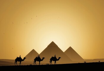 Silhouetted camels with riders near pyramids in a desert landscape