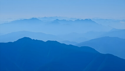 Layered blue mountain ranges fading into atmospheric haze image