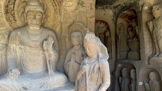 Pan of Prabhutaratna Grotto with statues of lotus holding Avalokitesvara, Sakyamuni and Prabhutaratna at Thousand-Buddha Cliff in Guangyuan, Sichuan, China, constructed from late Northern Wei Dynasty.