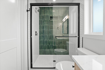 Bathroom with a glass shower door and a toilet
