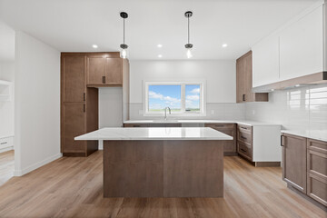 Kitchen with a white island and a window
