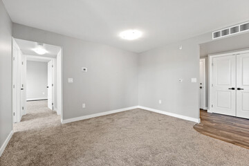 Large, empty room with a light shining on the floor