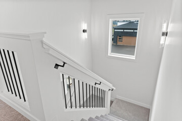 Staircase with a window above it