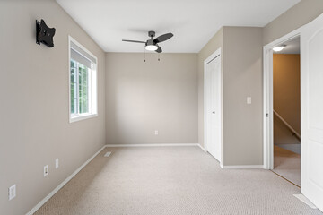 White room with a black fan and a black cat mounted on the wall
