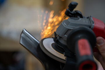 Obraz premium Angle Grinder Cutting Steel with Sparks Flying