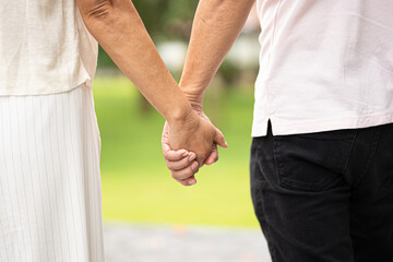 Couple, back and holding hands outdoor.