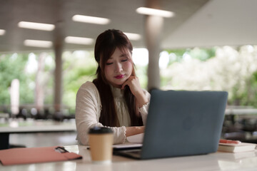 Fototapeta premium Asian adult woman remote work outdoor cafe laptop productivity focus business study digital nomad lifestyle connect online entrepreneurship success future