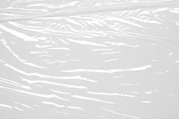 plastic overlay texture of realistic crumpled transparent plastic film wrap on white background,wrinkled stretched plastic effect.abstract grunge transparent plastic background