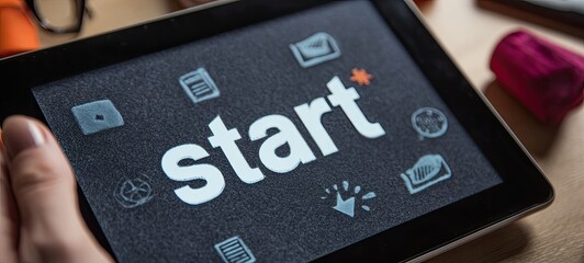 Tablet screen displaying the word "Start" surrounded by application icons