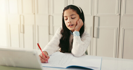 Girl, child and writing with homework, book and tablet for e learning, maths and problem solving...