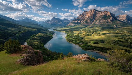 High-angle view of a serene mountain valley with a winding river and vibrant meadow